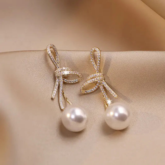 Gold Pearl Earrings with Shiny Bow Unique Joyas